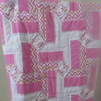 pink and white baby quilt