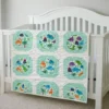 dinosaur world baby quilt on crib