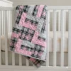 pink plaid baby quilt on crib