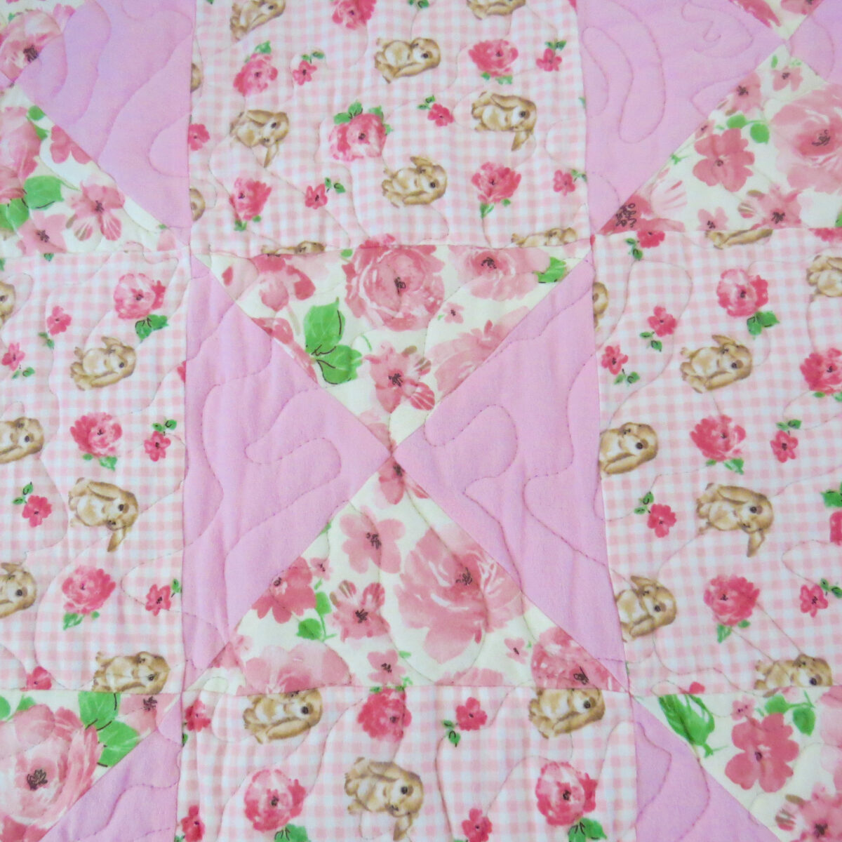 Bunny Trails Baby Quilt closeup of bow blocks
