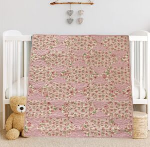 Bunny Trails Baby Quilt draped on white crib with bear