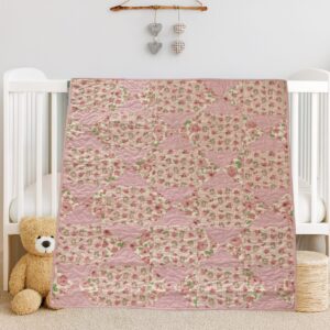 Bunny Trails Baby Quilt draped on white crib with bear