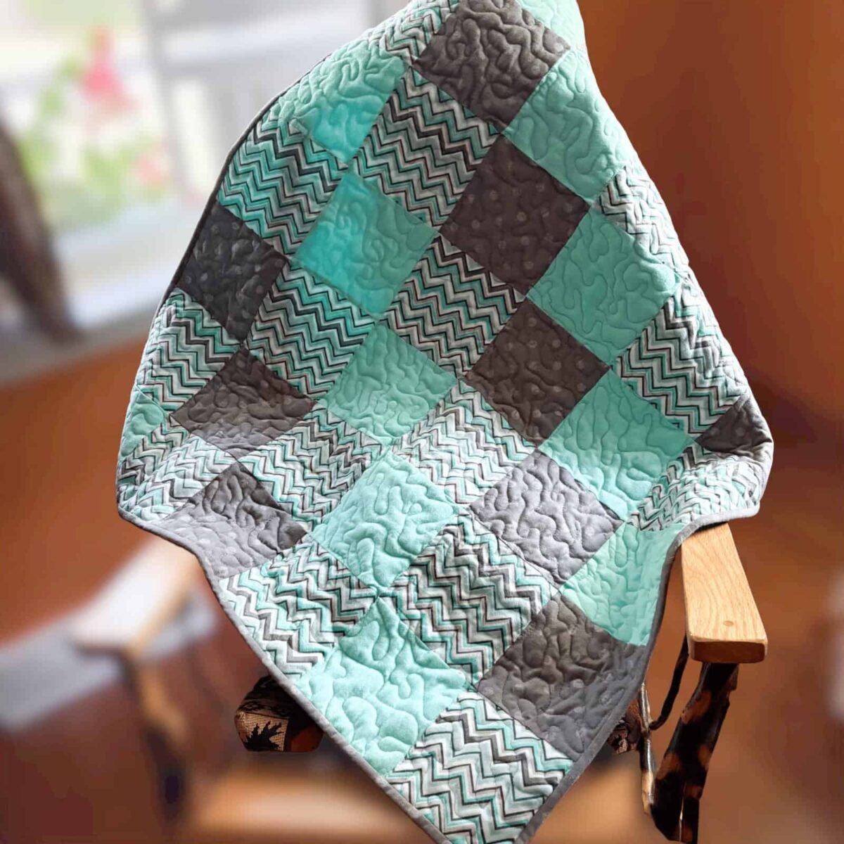 Coastal Calm Baby Quilt on chair Aqua and Gray