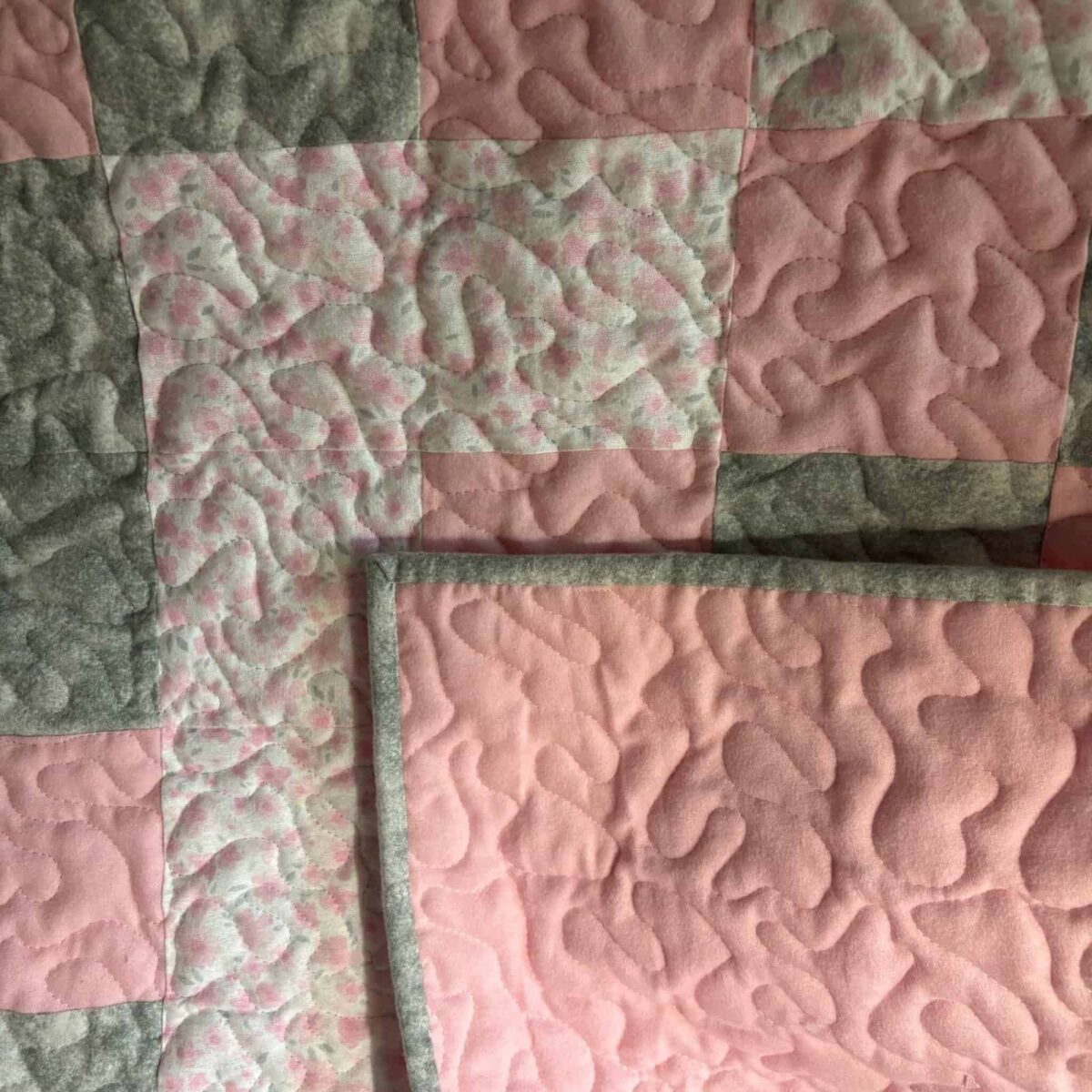 Blush and Bloom Baby Quilt with backing folded to front