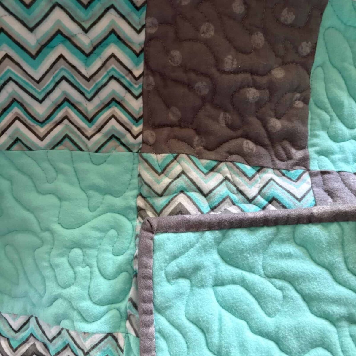 Coastal Calm Baby Quilt teal and gray baby quilt with backing visible