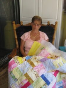 Shaorn with handmade baby quilts