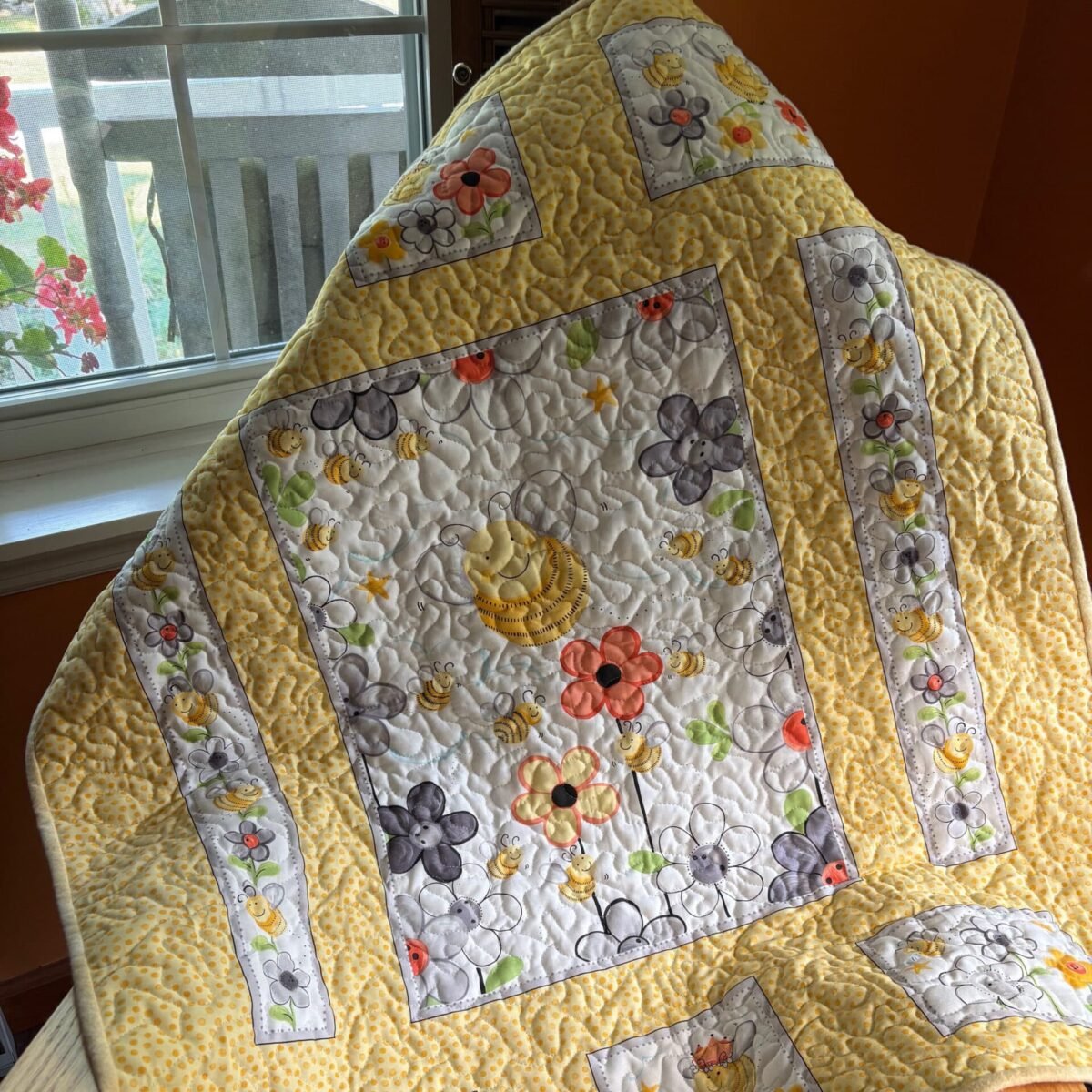 Buzzing Blooms Baby Quilt on Chair