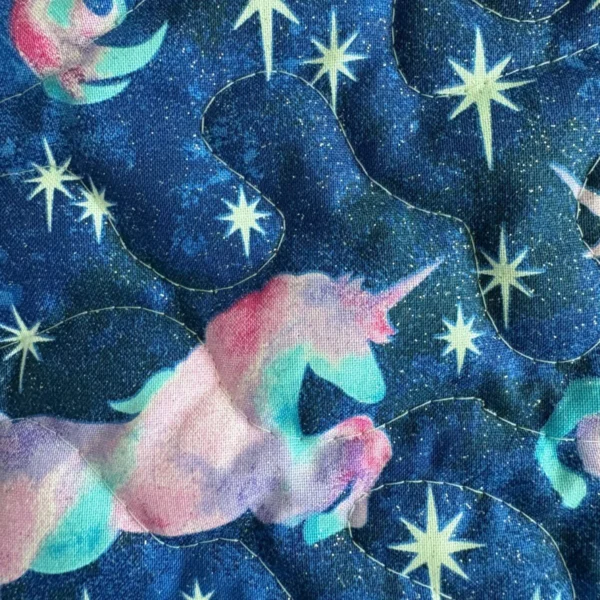 unicorn detail on patchwork quilt