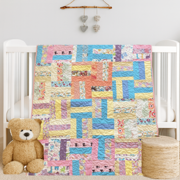 Handmade pastel patchwork quilt for toddlers featuring floral and animal prints.