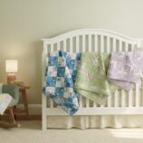 nursery scene with quilts draped on crib