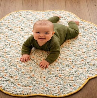 Bunny Flowers Playmat with baby in green onesie