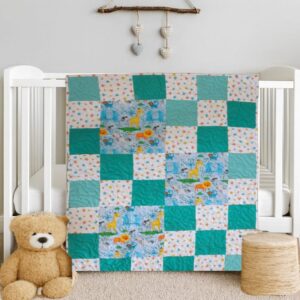 Adorable Animals ABC Baby Quilt on white crib with teddy bear