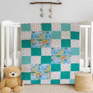 Adorable Animals ABC Baby Quilt on white crib with teddy bear