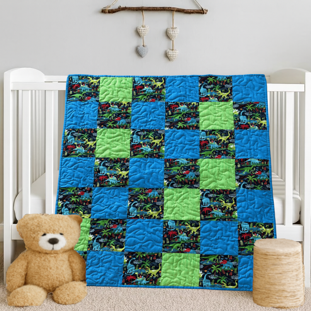 Dinosaur Dreams Baby Quilt on white crib with bear