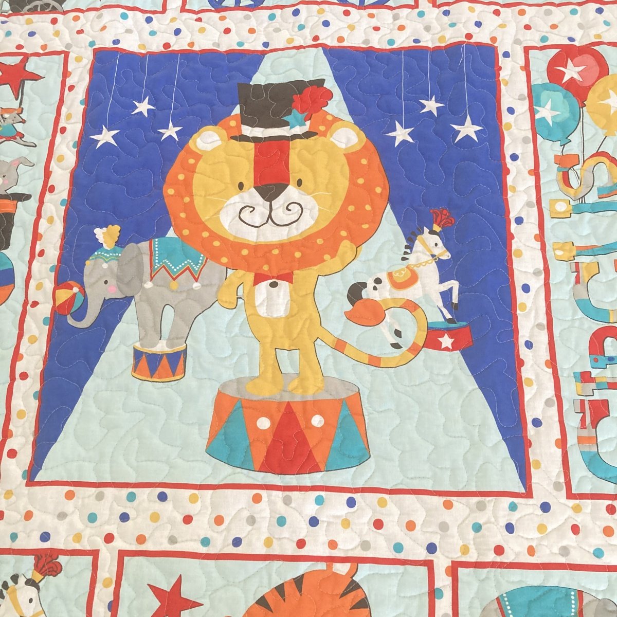 Circus Parade Baby Quilt with detail of lion