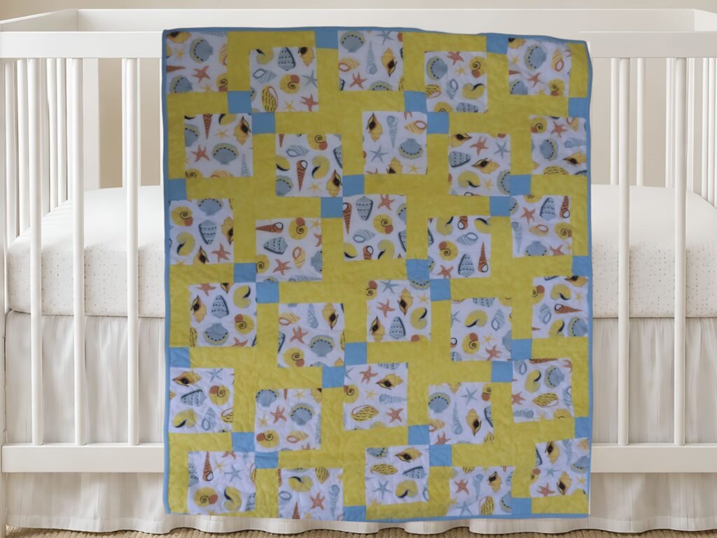 Seashells and Sand New Product Image on white crib